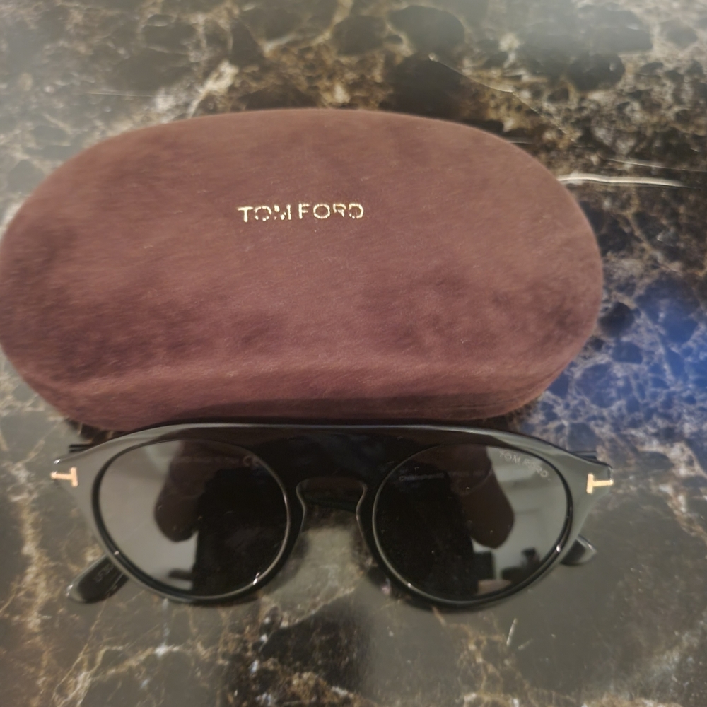 Tom Ford unisex sunglasses in the color black with gold accents with case.